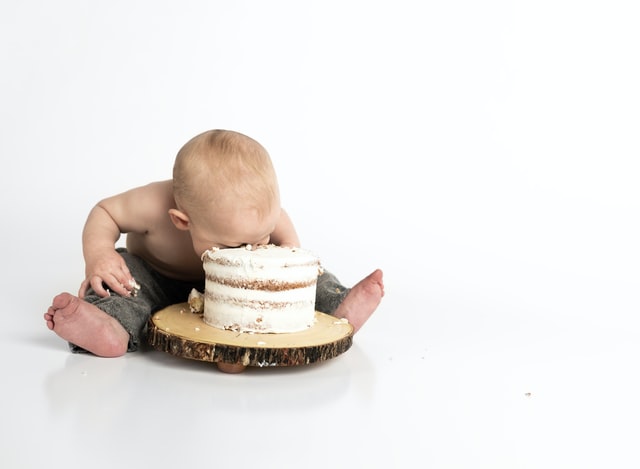 baby with face in cake